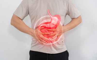 Person holding their abdomen with a red stomach graphic indicating abdominal pain or digestive distress.